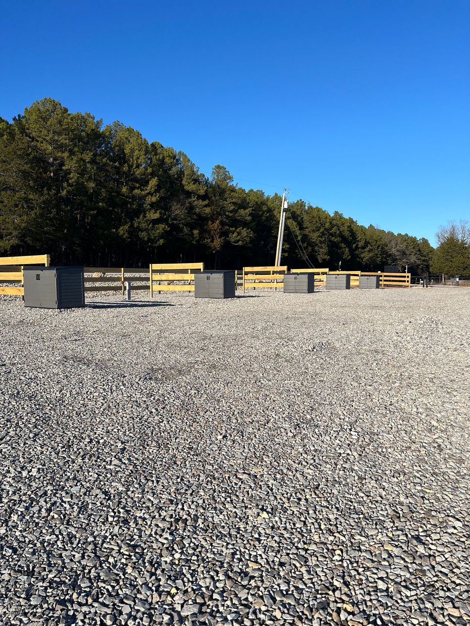 Sign for White River RV Resort, snowy field, blue sky. Phone number: 870-404-9909.